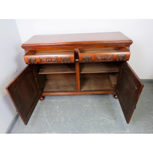 880 - An Art Nouveau mahogany sideboard, the two short drawers with ornately cast handles and relief carvi... 