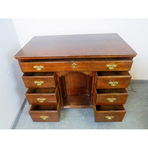 882 - An 18th century oak chest with one long drawer over six graduated drawers and central kneehole with ... 