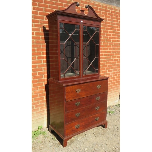 886 - A Georgian Revival secretaire bookcase, featuring scrolled pediment over astral glazed doors opening... 