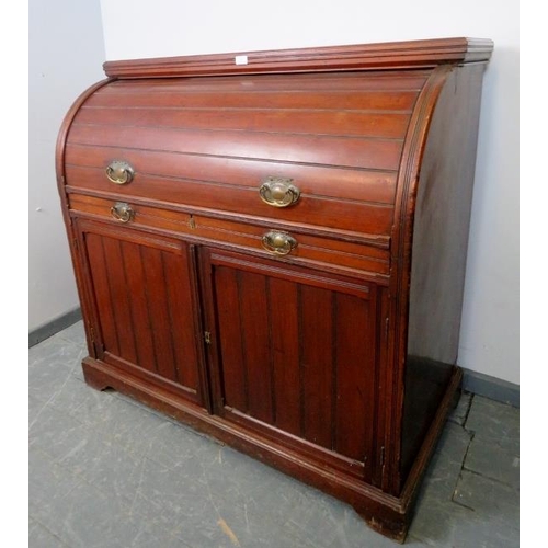 887 - An Edwardian mahogany cylinder desk, the lid opening onto a fitted interior featuring light oak draw... 