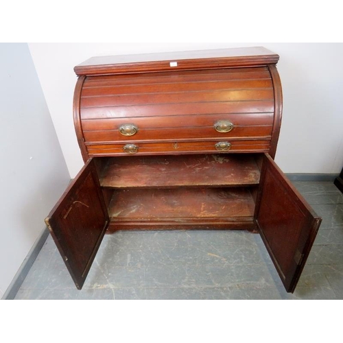 887 - An Edwardian mahogany cylinder desk, the lid opening onto a fitted interior featuring light oak draw... 