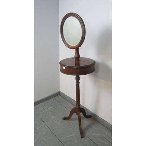 888 - A Victorian mahogany shaving stand with adjustable circular bevelled mirror, over two lidded compart... 