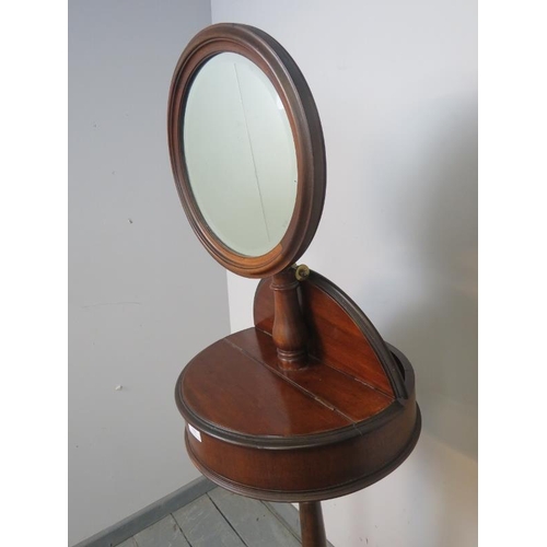 888 - A Victorian mahogany shaving stand with adjustable circular bevelled mirror, over two lidded compart... 