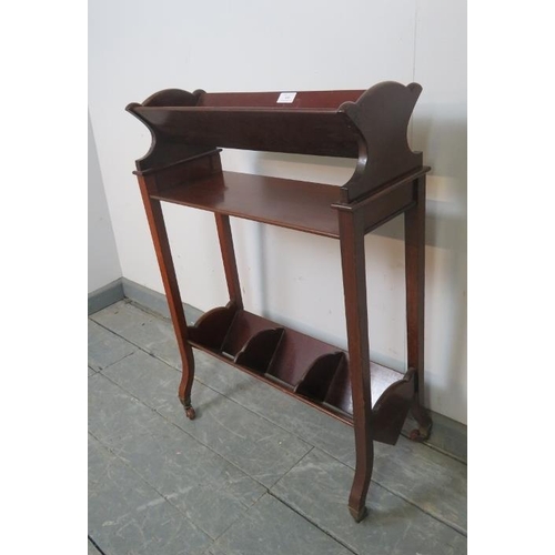 890 - An Edwardian mahogany two-tier freestanding book trough on square supports with ceramic castors.
Con... 