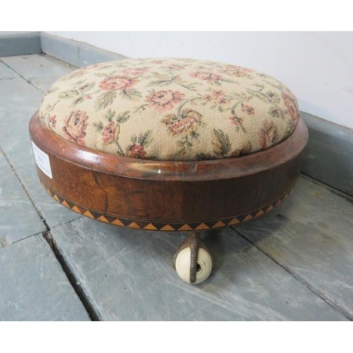 891 - A Victorian circular bun footstool with tapestry top and parquetry inlay, on gilt bronze claw feet w... 