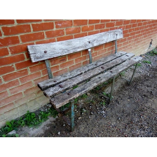 897 - A weathered antique garden bench, the oak slats on iron strapwork supports, bearing remnants of the ... 