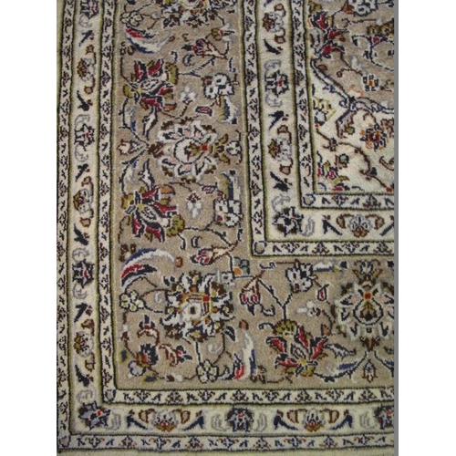 905 - A good Persian Kashan carpet, decorated with a busy scrolling foliate design on a muted pale green g... 