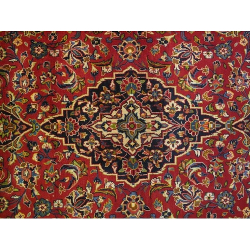 906 - A Persian Kashan rug, decorated with a central stylised medallion on blue ground, within stylised fo... 