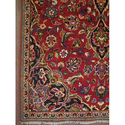 906 - A Persian Kashan rug, decorated with a central stylised medallion on blue ground, within stylised fo... 