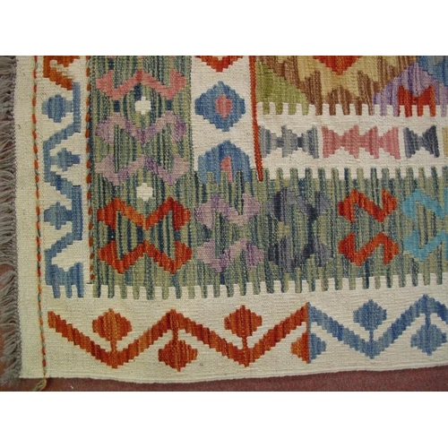 908 - A Persian Anatolian Kilim rug, new, decorated with traditional geometric motifs on pale and muted gr... 