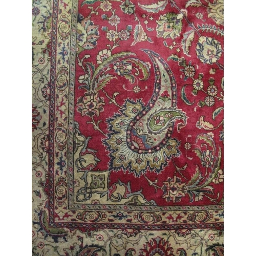 909 - A good Persian Tabriz carpet, decorated with a central medallion amidst stylised foliage on a red gr... 