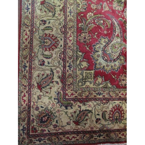 909 - A good Persian Tabriz carpet, decorated with a central medallion amidst stylised foliage on a red gr... 