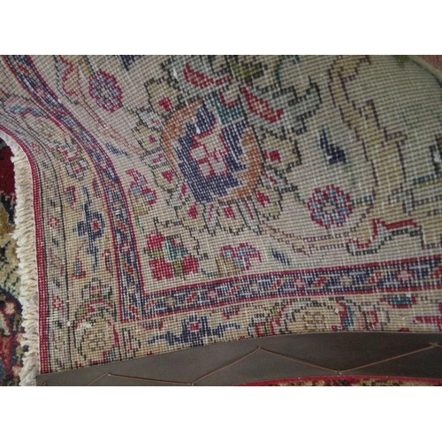 909 - A good Persian Tabriz carpet, decorated with a central medallion amidst stylised foliage on a red gr... 