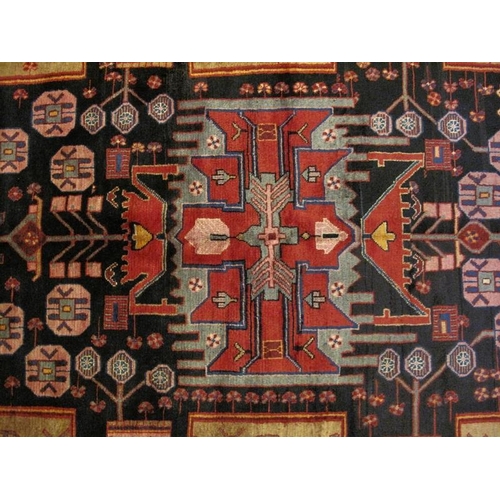 910 - A Persian Nahawand rug, new, decorated with a vibrant pattern of traditional motifs on a predominate... 