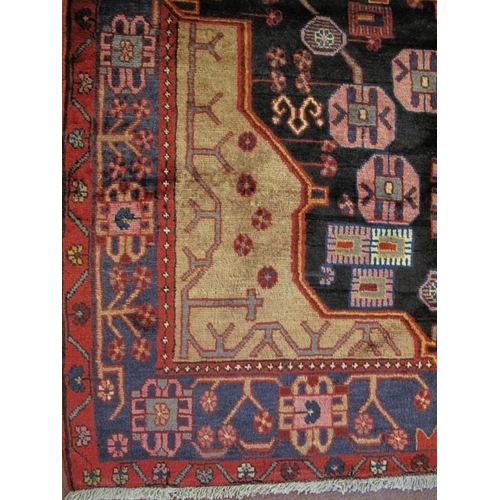 910 - A Persian Nahawand rug, new, decorated with a vibrant pattern of traditional motifs on a predominate... 