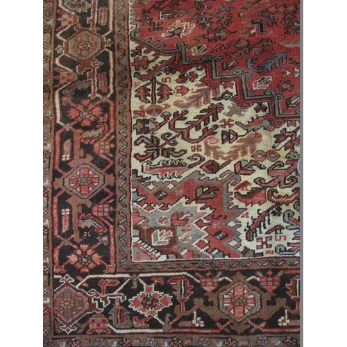 913 - A good Persian Heriz carpet, decorated with central medallion and stylised motifs predominantly on a... 