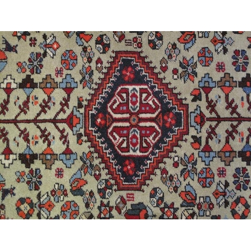 916 - A Persian rug, 20th century, decorated with a central lozenge medallion amidst stylised motifs and s... 