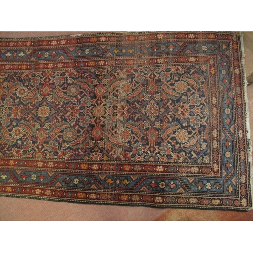 918 - An antique/vintage Persian runner, probably 19th/early 20th century, decorated with a busy stylised ... 