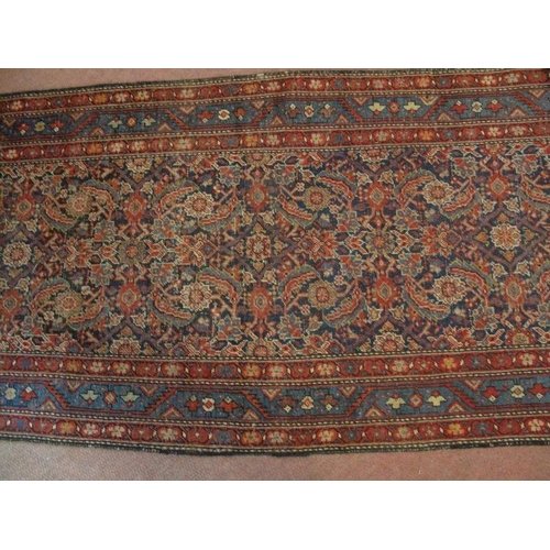 918 - An antique/vintage Persian runner, probably 19th/early 20th century, decorated with a busy stylised ... 