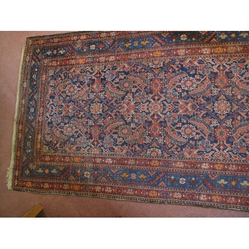 918 - An antique/vintage Persian runner, probably 19th/early 20th century, decorated with a busy stylised ... 