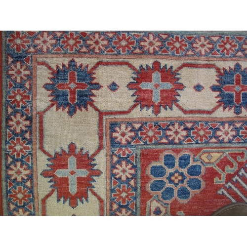 922 - A Persian rug, 20th century, 100% woven wool, decorated with stylised traditional motifs on red, blu... 