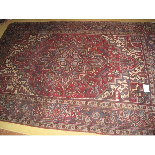 929 - A mid 20th century Persian carpet, central motif on a claret field. 189cm x 273cm.
Condition report:... 