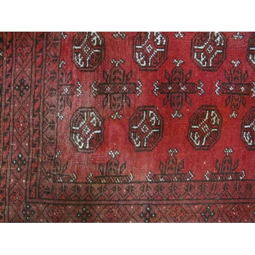 932 - A nice quality vintage Persian rug, decorated with a central field of stylised motifs within deep ba... 