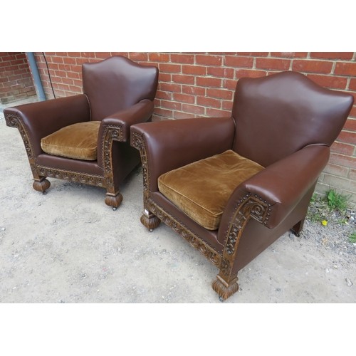 717 - A pair of good quality turn of the century carved oak framed club armchairs, upholstered in brown le... 