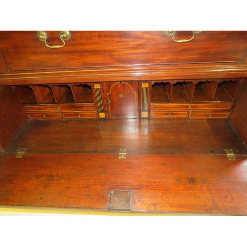 702 - A fine George III mahogany secretaire chest on chest, the top housing two short over three long grad... 