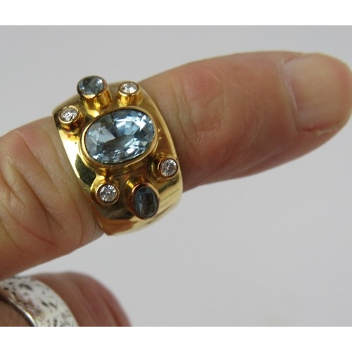 440 - A heavy 18ct yellow gold wide banded ring set with aquamarines & diamonds. Centre aquamarine approx ... 