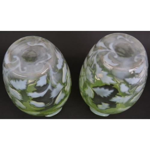 106 - A pair of antique graduated green Vaseline glass vases with foliate design. Ground pontils to bases,... 