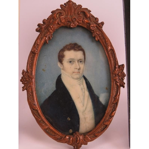 123 - A 19th century miniature portrait of a gentleman mounted in a bronzed metal easel frame, a similar p... 