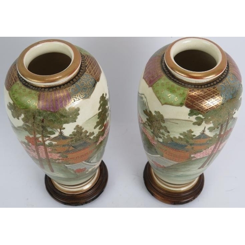 13 - A pair of finely decorated Japanese Satsuma vases with traditional Mount Fuji scenes standing on tur... 