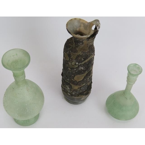 131 - Three hand blown Roman style glass flasks, one with handle. Tallest 19cm. (3).
Condition report: No ... 