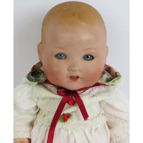 133 - A Bisque headed Armande Marseille baby doll marked AM Germany 351/5k. Cotton and ribbon gown and cap... 