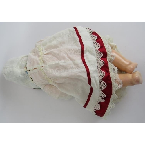 133 - A Bisque headed Armande Marseille baby doll marked AM Germany 351/5k. Cotton and ribbon gown and cap... 