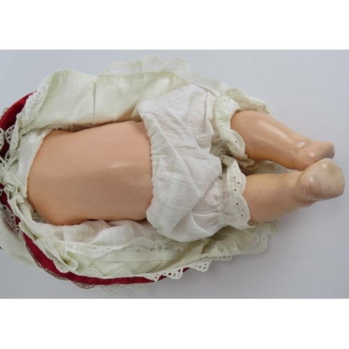 133 - A Bisque headed Armande Marseille baby doll marked AM Germany 351/5k. Cotton and ribbon gown and cap... 