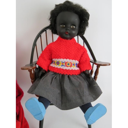 134 - A vintage 1950s pedigree black doll with red dress and bonnet and a 1970s 'Roddy' black plastic doll... 