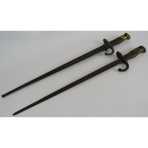 139 - Two late 19th/early 20th century French bayonets one with steel scabbard. Both numbered and with arm... 