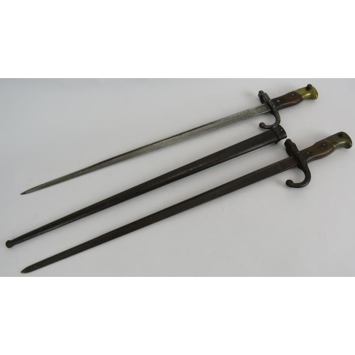 139 - Two late 19th/early 20th century French bayonets one with steel scabbard. Both numbered and with arm... 