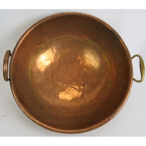 149 - A large heavy copper bowl with rivetted handles, diameter 42cm, a large copper funnel/light shade an... 