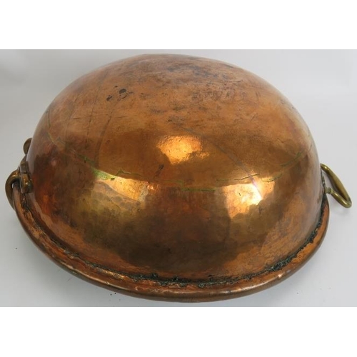 149 - A large heavy copper bowl with rivetted handles, diameter 42cm, a large copper funnel/light shade an... 