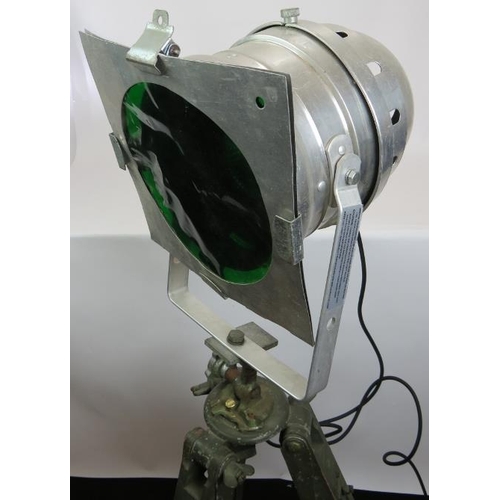 153 - An aluminium PAR 64S theatre light with green lens mounted on a vintage green wooden adjustable trip... 