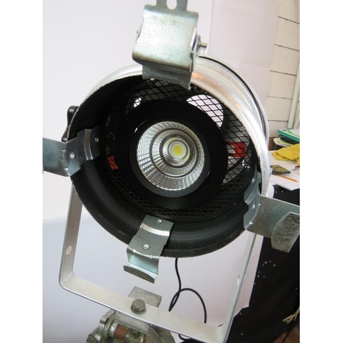 153 - An aluminium PAR 64S theatre light with green lens mounted on a vintage green wooden adjustable trip... 