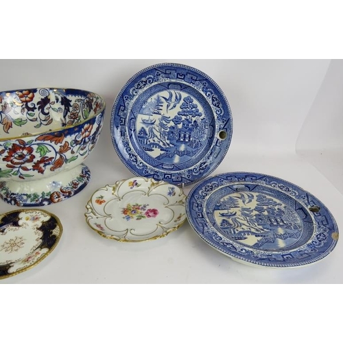 167 - A large footed ironstone bowl, two Willow pattern heated plates, a similar dish, a Royal Doulton Bun... 