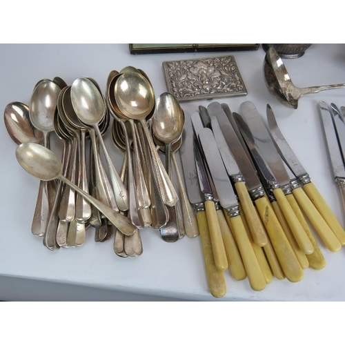 181 - A large quantity of silver plated cutlery, serving ware, decanter labels, cigarette case etc. (Qty).... 