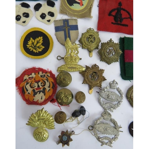 183 - A collection of WW2 British and Canadian military cap badges and cloth badges including Tank Corps, ... 