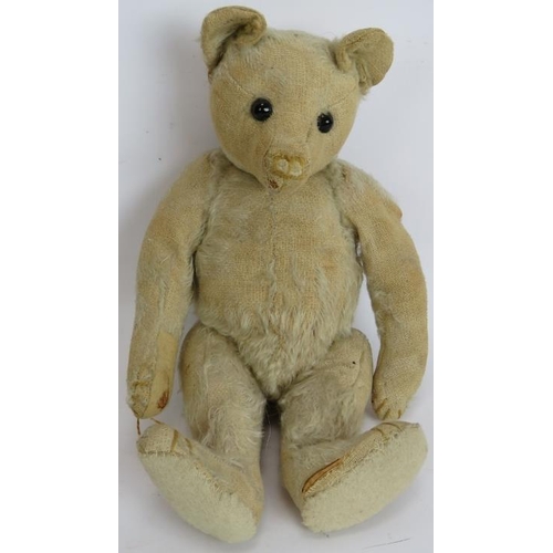 195 - An antique straw filled jointed teddy bear with long snout, hump back and jointed arms, legs and nec... 