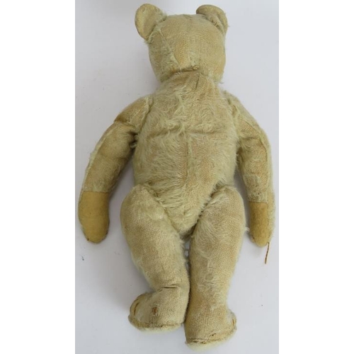 195 - An antique straw filled jointed teddy bear with long snout, hump back and jointed arms, legs and nec... 