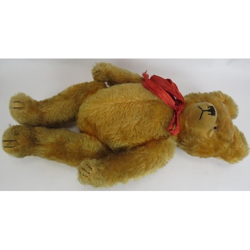 195 - An antique straw filled jointed teddy bear with long snout, hump back and jointed arms, legs and nec... 